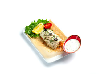 baked fish fillet with tomato, lemon, herbs and sauce on an isolated white background