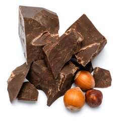 Dark or milk organic chocolate pieces ant hazelnuts isolated on white background