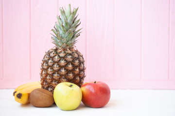 Mix fruits background. Fresh fruits. Healthy eating, dieting concept, clean eating. Pineapple and apples on white background
