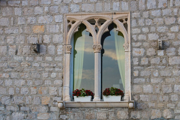 Window in the facade of old house from the end of fifteen century in Venetian gothic style in Bol...