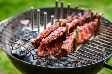 Baby Back Spare Ribs Roast on BBQ barbecue kettle grill.