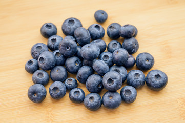 Natural looking blueberries on wooden background. Selective focus.