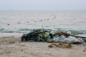 a heap of trash on the beach in Thailand. The rubbish that lurks in the sea, which has been stormed into the sea, has a lot to offer during the monsoon season. Contamination of the environment concept
