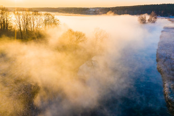 Amazing morning landscape. Countryside covered in fog aerial. River in morning