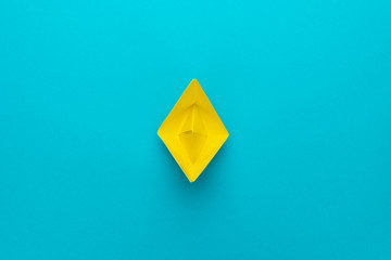 minimalist photo of yellow paper ship with copy space. loneliness concept