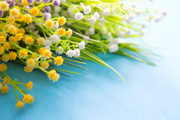 Bouquet of wildflowers on the old wood background