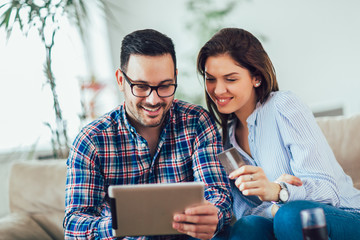 Young couple shopping on internet with digital tablet