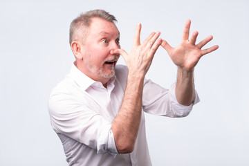 senior man in white shirt teasing somebody