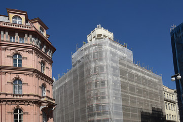 Fototapeta na wymiar building under construction with protective tarpaulin