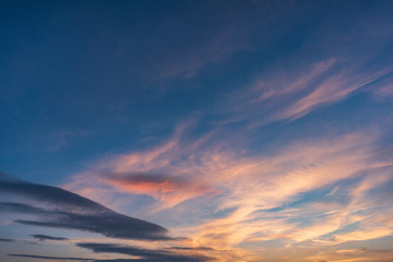 Beautiful sunset sky above clouds with dramatic light. Cabin view from airplane