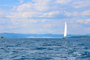 large sailboat in the Adriatic sea on blue and cloud sky background