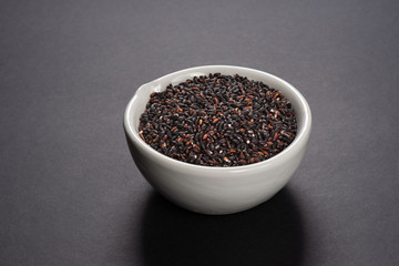 uncooked black wild rice in a bowl