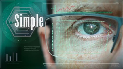 A close up of a businessman eye controlling a futuristic computer system with a Simple Business concept.