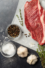 Macro tasty cut of beef on craft paper at gray concrete background