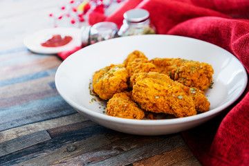 Chicken Wings Spicy chicken wings, breaded, fried, cooked.