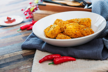Chicken Wings Spicy chicken wings, breaded, fried, cooked.