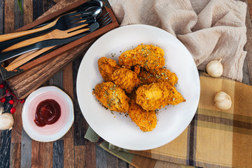 Chicken Wings Spicy chicken wings, breaded, fried, cooked.