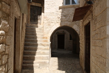Fototapeta na wymiar Narrow street of the old town of Trogir, Croatia