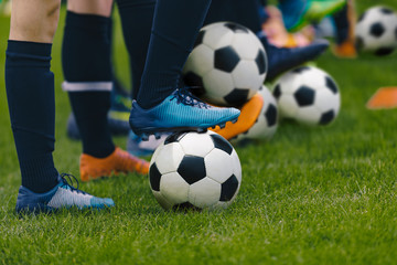 Junior Football Training Session. Players Standing in a Row with Classic Black and White Balls....