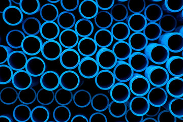 The front image shows the cutting face of the blue PVC pipe. That are arranged on the floor of the construction materials wholesale warehouse. Can be used as a abstract background image.