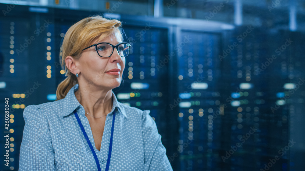 Fototapete portrait of a beautiful senior female it technician standing in modern data center. in the backgroun