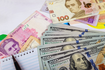 Denominations of the Ukrainian hryvnia of the bills in the under the bills a fragment of the US dollar bill.