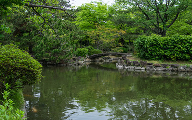 Fototapeta na wymiar Himeji Castle Garden, japanese Garden, with bridge, koys, water and flora. Himeji, Hyogo, Japan, Asia.