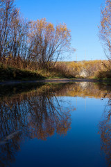 Autumn day in Arkhangelsk. Island Krasnoflotsky. the reflection in the water