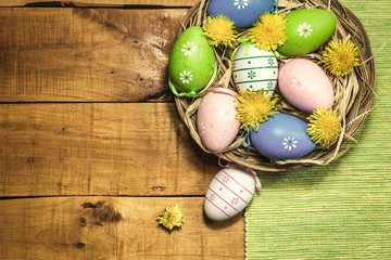 Colorful Easter eggs on wooden background