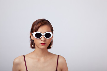 Fototapeta premium Chinese Girl wearing varies types of fashion sunglasses,looking sharp