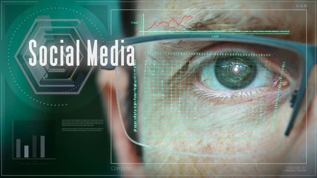 A close up of a businessman eye controlling a futuristic computer system with a Social Media Business concept.