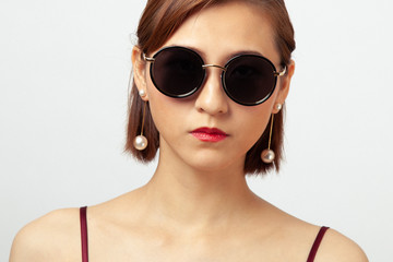 Chinese Girl wearing varies types of fashion sunglasses,looking sharp