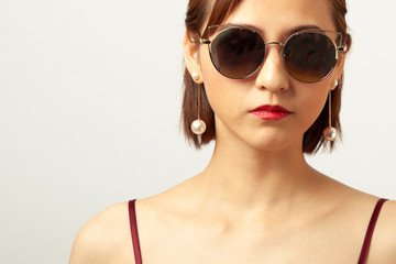 Chinese Girl wearing varies types of fashion sunglasses,looking sharp