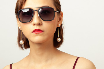 Fototapeta na wymiar Chinese Girl wearing varies types of fashion sunglasses,looking sharp