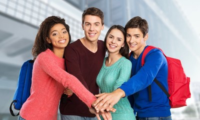 Cropped photo of friends in check shirts holding their hands together in shape of sun