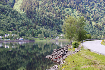 Fototapeta na wymiar Mountain road near fjord
