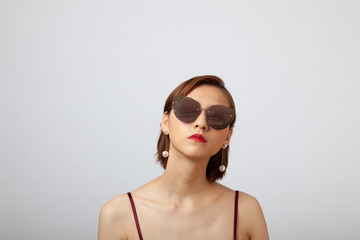 Chinese Girl wearing varies types of fashion sunglasses,looking sharp