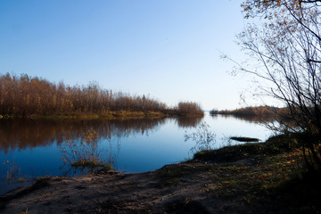 Fototapeta premium Autumn day in Arkhangelsk. Island Krasnoflotsky. the reflection in the water