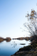 Naklejka na ściany i meble Autumn day in Arkhangelsk. Island Krasnoflotsky. the reflection in the water