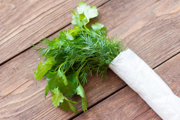 fresh dill and parsley on a wooden background,close-up,selective focus