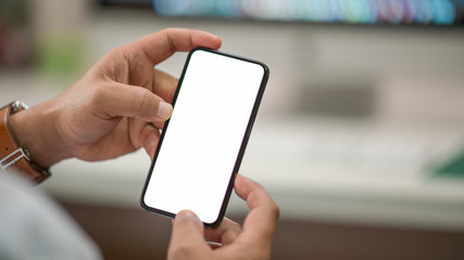 Business man showing blank screen mobile phone in office