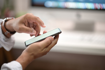 Young man with smartphone in office