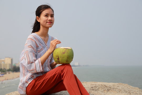 Woman Drink Coconut Juice In Samson Beach In Vietnam