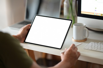 Business man using digital tablet on office workspace.