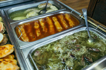 A set of meat dishes in the trays