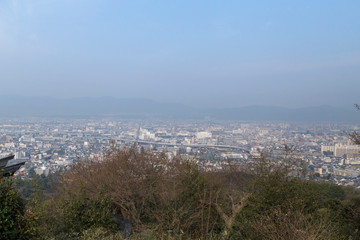 Fototapeta na wymiar View of Kyoto from Mount Fushimi Inari during the Hanami on a clear day