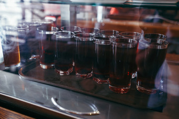 Pastry shop display window of delicatessen store with variety of cakes.