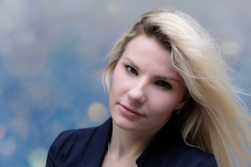 Obraz premium Portrait of happy smiling young cheerful businesswoman standing with flowing hair. Success in business concept studio shot. Blue suit. Multicolor wall background.