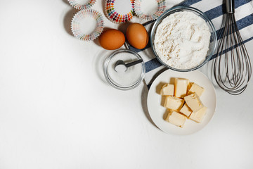 White background. Food accessories. A variety of ingredients for making dough.Top view cupcake recipe concept. Flat Lay. Copy space for text