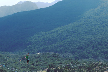Woman balancing on the rope concept of risk taking and challenge.